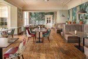 a restaurant with tables and chairs and a couch at Rufflets St Andrews in St. Andrews
