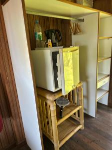a microwave sitting on top of a table in a kitchen at Pension Vaimano-Raivavae in Vaiuru +27 photos