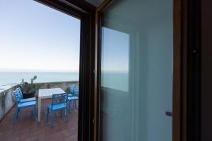 a balcony with a table and chairs and the ocean at Appartamenti Castello in Peschici