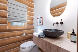 a bathroom with a vessel sink and wooden walls at 526 Alan Rd - Durango CO. in Durango +40 photos