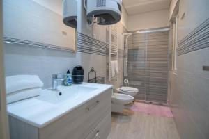 a bathroom with a white sink and a toilet at B&B Cannito in Altamura