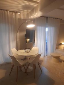 a room with a table and chairs and a bed at Nature Nest in Larisa
