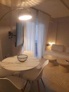 a room with a table and chairs and a bed at Nature Nest in Larisa