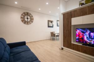 a living room with a blue couch and a tv at B&B Cannito in Altamura