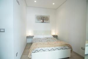 a bedroom with a bed in a white room at B&B Cannito in Altamura