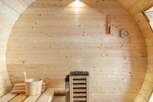 an inside view of a sauna with a wooden wall at GIAMI affittacamere & SPA in Santa Giustina +22 photos