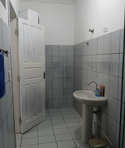 a white bathroom with a sink and a shower at Casa em Maceió Para Alojamento ou Família Grande in Maceió +15 photos