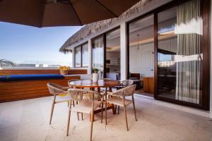 a dining room with a table and chairs at Elegance - Jungle meet with private pool heated in Bucerías