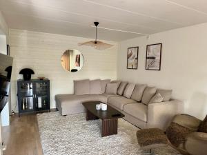 a living room with a couch and a table at Hus, barnvänligt, nära strand in Halmstad