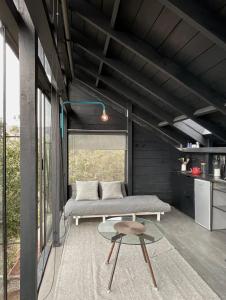 a room with a bed and a table in it at Refugio costero Molle in Boca Pupuya +10 photos