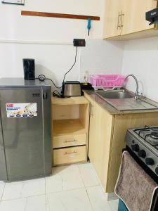 a kitchen with a refrigerator and a sink at Residence Next Door Gz in Kiambu