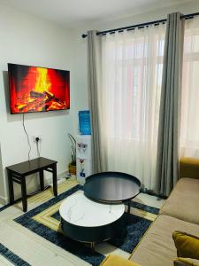 a living room with a couch and a table at Residence Next Door Gz in Kiambu