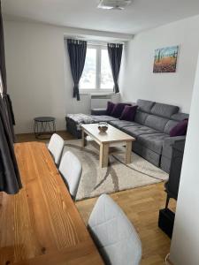 a living room with a couch and a table at Apartman Zimski Kutak in Kupres