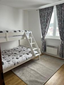 a white bunk bed in a room with a window at Apartman Zimski Kutak in Kupres