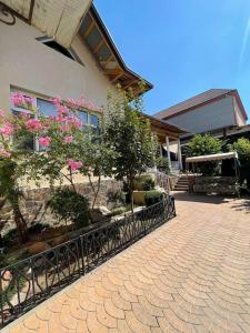a house with a fence in front of a building at Hotel Home in Tashkent