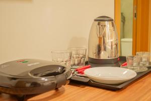 a toaster sitting on top of a table with glasses at Viamar Home in Natal