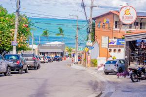 a street with cars parked on the side of the road at Viamar Home in Natal