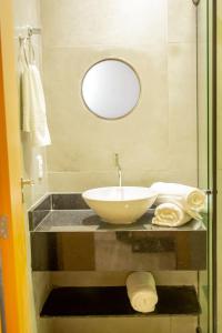 a bathroom with a bowl sink and a mirror at Viamar Home in Natal +16 photos
