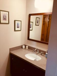 a bathroom with a sink and a mirror at Durango Colorado Four Bedroom Two Bathroom Home in Durango +8 photos