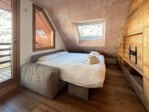 a small bedroom with a bed and a window at Sky nest - Matterhorn in Breuil-Cervinia