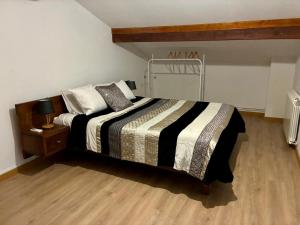 a bedroom with a bed and a wooden floor at Casa Vilariça in Alfândega da Fé
