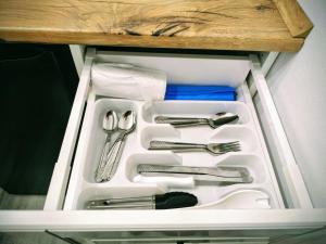 a drawer with silver utensils in a refrigerator at Modern Studio AFI Arad Self Check-in in Arad