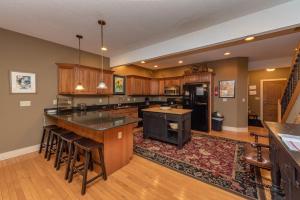 a large kitchen with wooden cabinets and an island at Dream On by Railey Vacations in Oakland +45 photos