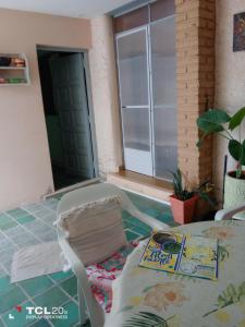a room with a chair and a book on the floor at Hospedaje LA LUCIA in Almafuerte