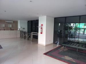 a lobby with a large glass building with a red fire extinguisher at Landscape Beira Mar in Fortaleza