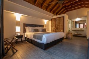 a bedroom with a large bed in a room at Hotel Santa Catalina By OxoHotel in Cartagena de Indias