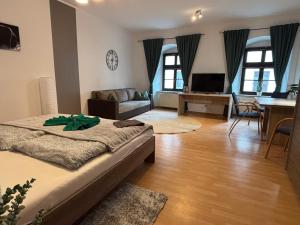 a bedroom with a bed and a living room at Macabu Apartment Porto in Plauen