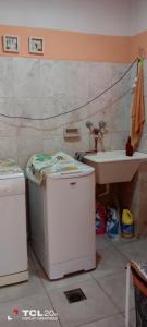 a bathroom with a washing machine and a sink at Hospedaje LA LUCIA in Almafuerte +12 photos