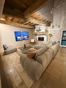 a large living room with a large couch and a tv at Grand Mas in Tarascon