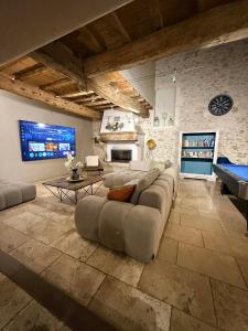 a large living room with a couch and a tv at Grand Mas in Tarascon