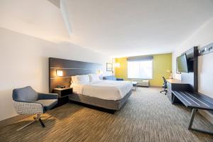 a hotel room with a bed and a desk and chair at Holiday Inn Express Winona by IHG in Winona