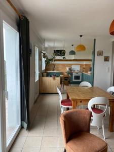 a kitchen and dining room with a table and chairs at Tall Ar Groas in Plogoff