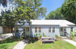 a blue house with a picnic table in front of it at St Augustine Island, King Bed, Beach Living in St. Augustine +10 photos