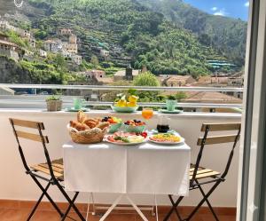 a table with food on it with a view of a mountain at Trifoglio Apartment in Maiori