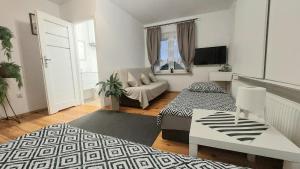 a living room with a couch and a table at AzyL25 in Starachowice