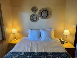 a bedroom with a bed with blue pillows and two lamps at Mountain Cabin at Heavenly in Stateline