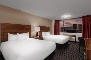 a hotel room with two beds and a window at The D Las Vegas in Las Vegas +13 photos