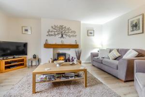 a living room with a couch and a coffee table at 3 Bed in Brithdir oc-c33971 in Llanfachreth