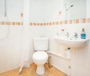 a bathroom with a toilet and a sink at The Annex @ 136 in Gloucestershire +19 photos