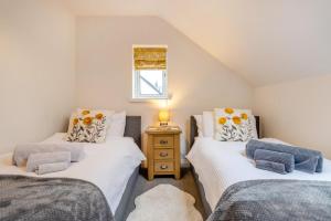 a bedroom with two twin beds and a night stand at 3 Bed in Brithdir oc-c33971 in Llanfachreth