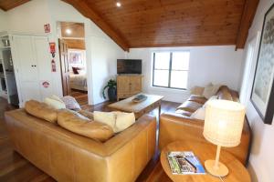 a living room with two couches and a table at Bonvilla Estate in Pokolbin