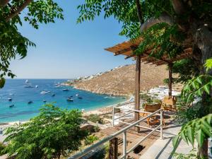 a view of a beach with boats in the water at Trinitas Mare Psarou Beach in Psarou
