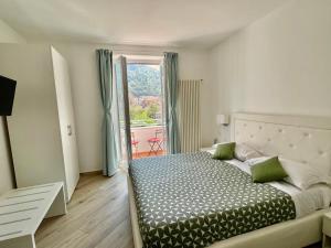 a bedroom with a bed and a large window at Trifoglio Apartment in Maiori
