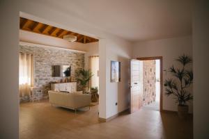 a living room with a couch and a television at Blue Petrol Room - Ocean Double Private Suite in Villa Barbuja in Tefía