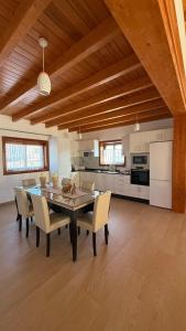 a kitchen and dining room with a table and chairs at Blue Petrol Room - Ocean Double Private Suite in Villa Barbuja in Tefía