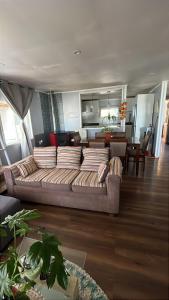 a living room with a couch and a dining room at Cabaña en Ancud in Ancud